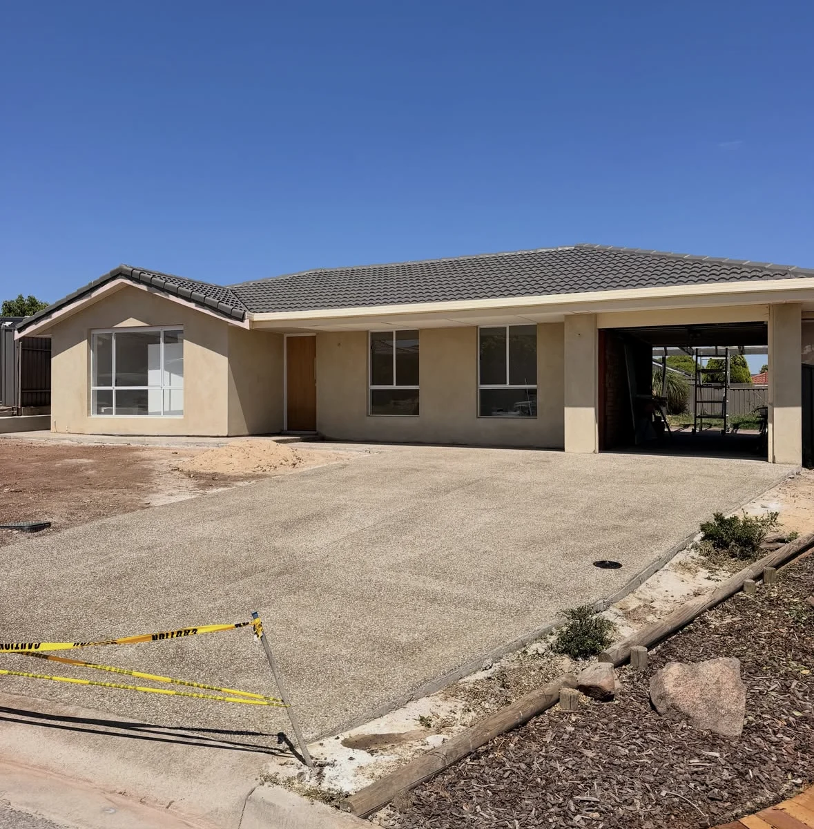 Exposed aggregate driveway and home at Redwood Park