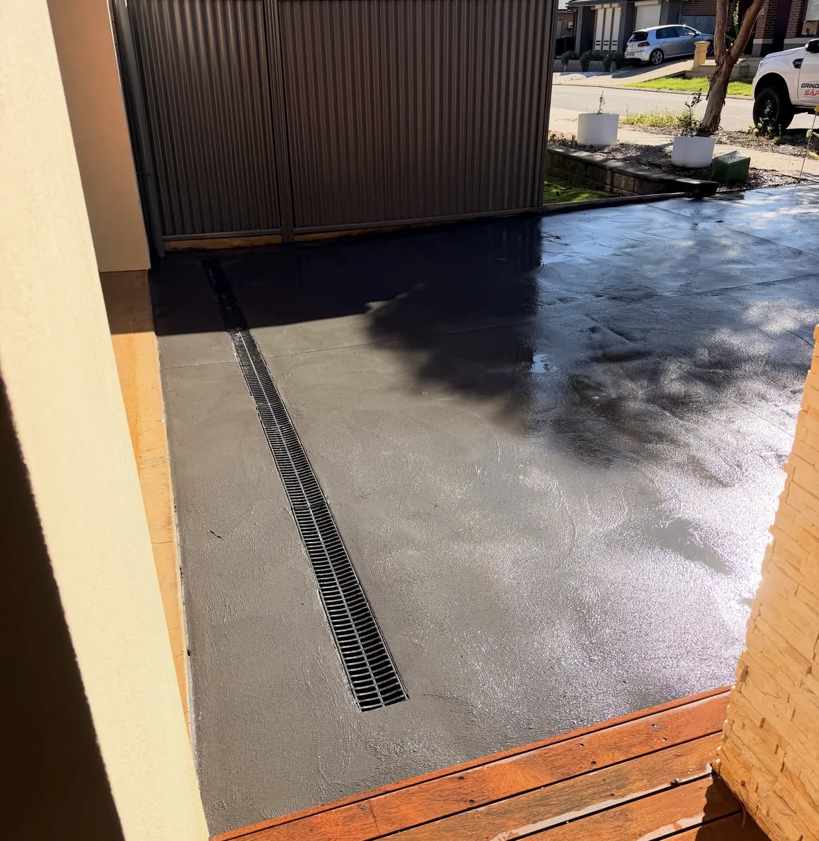 Charcoal concrete and drainage detail beside the Blakeview home